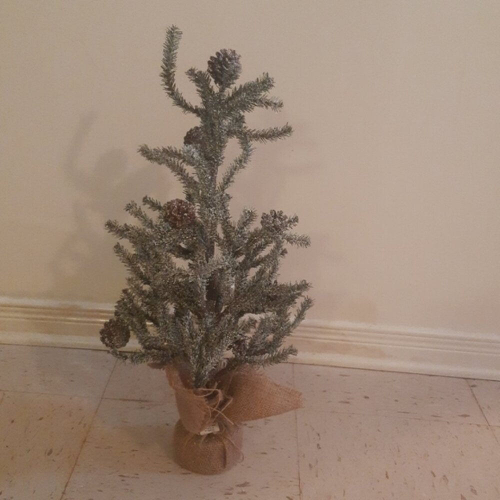 Artificial Christmas tree with snow and pinecones table top